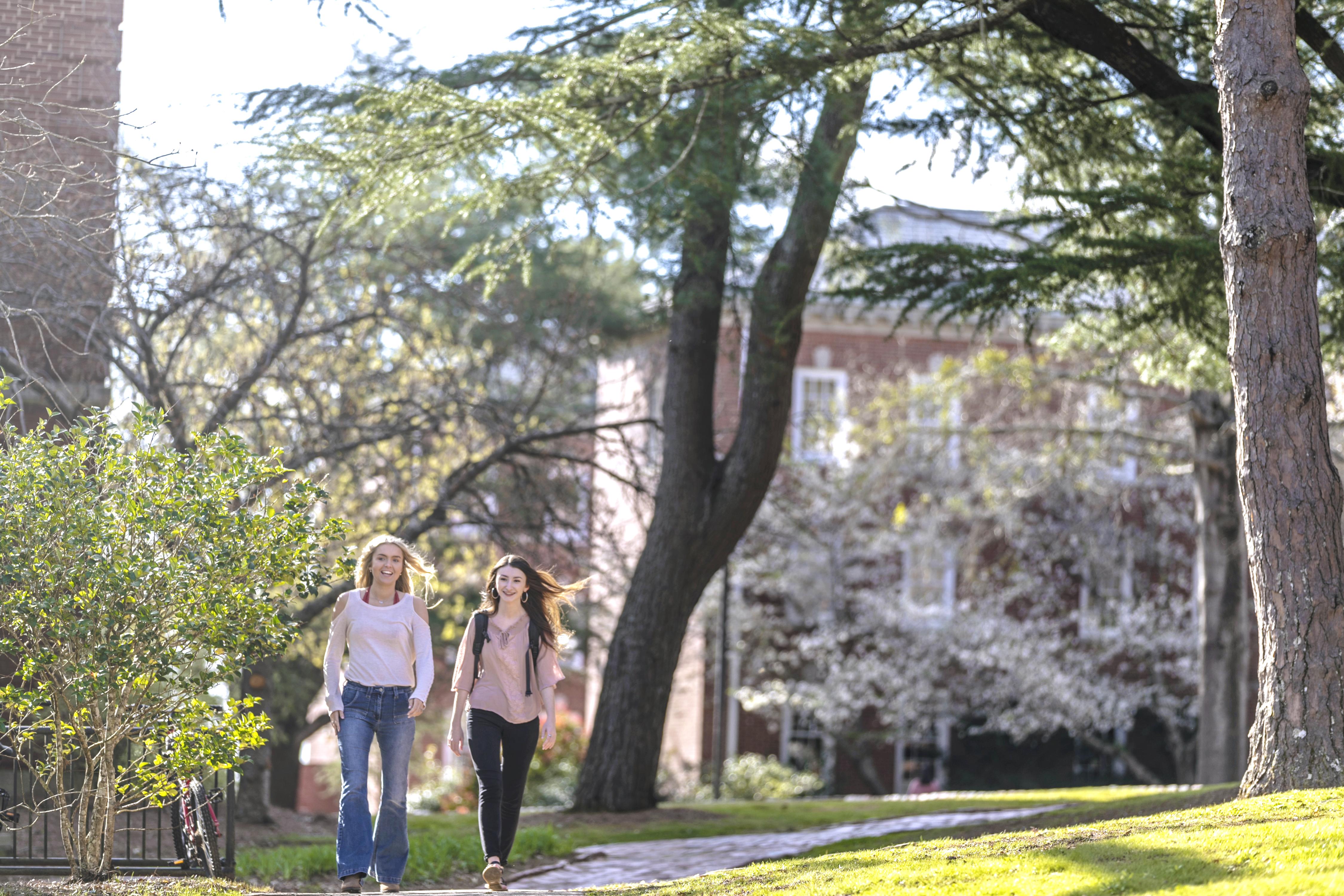 two girls walking on campus