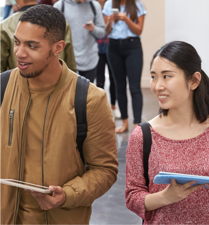 Students smiling while they are walking.