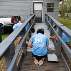 Montevallo students paint a porch during the Big Event day of community service.