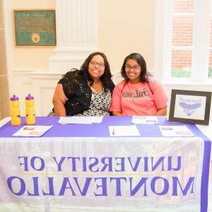 Two Falcon Scholars in Action members present information at the Volunteer Fair.